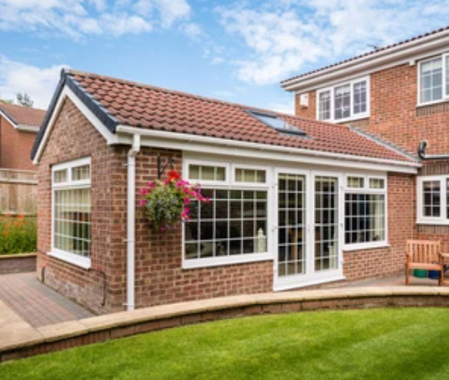 Rear of a home with new windows and a conservatory