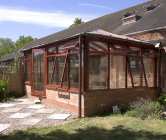 Hardwood conservatory with a glazed roof