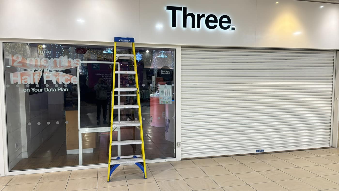 Retail shopfront with glazing and a security shutter in a shopping centre