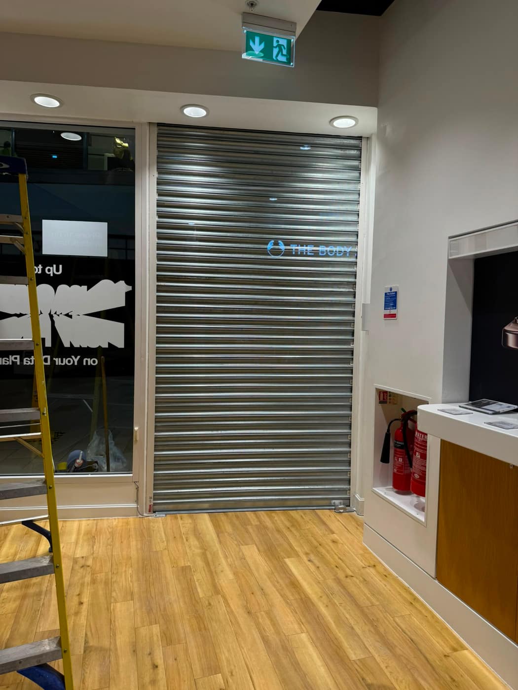 Galvanised retail roller shutter fitted inside a store