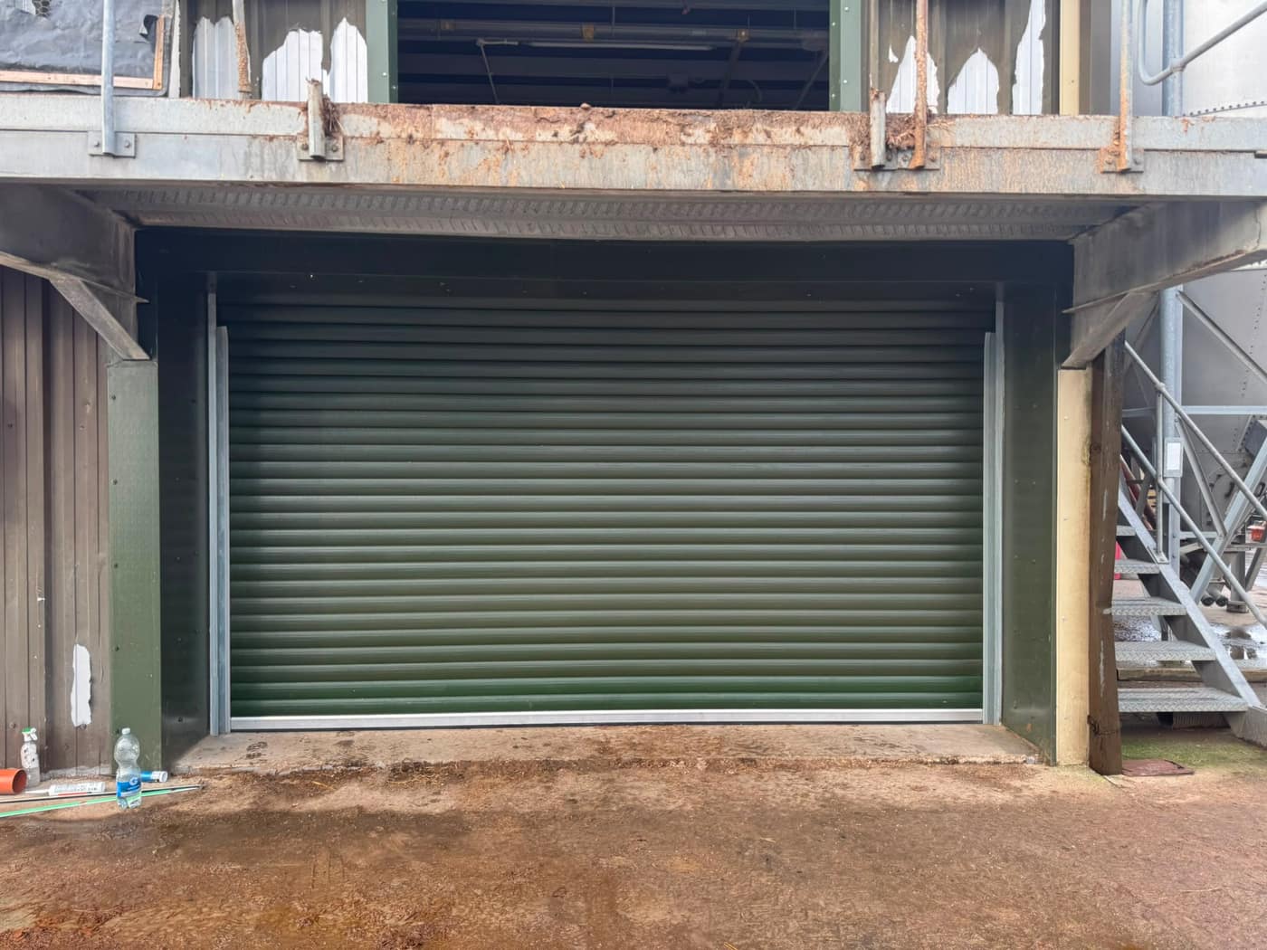 Green roller shutter fitted to a loading bay
