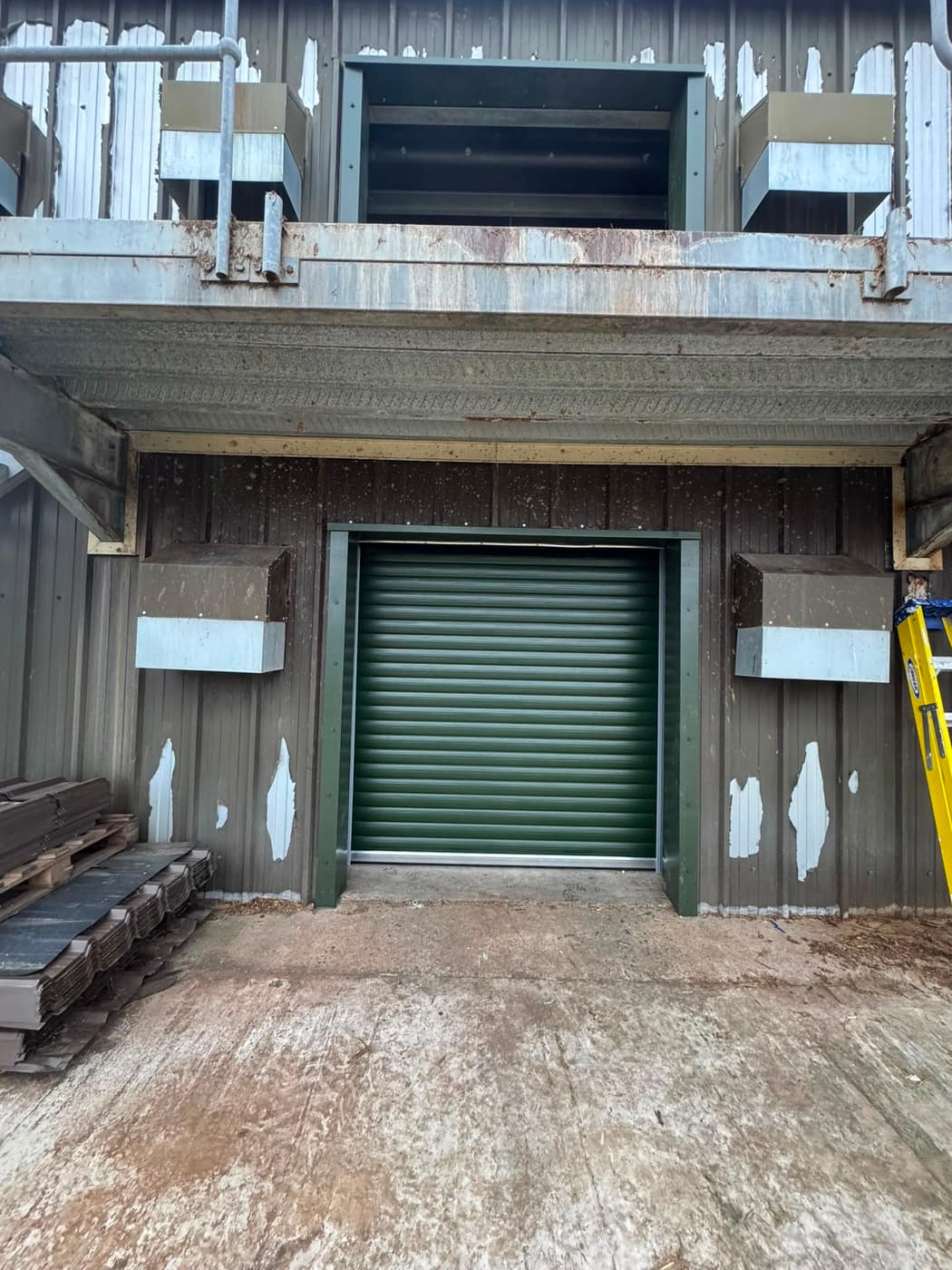 New green roller shutter fitted to an industrial unit