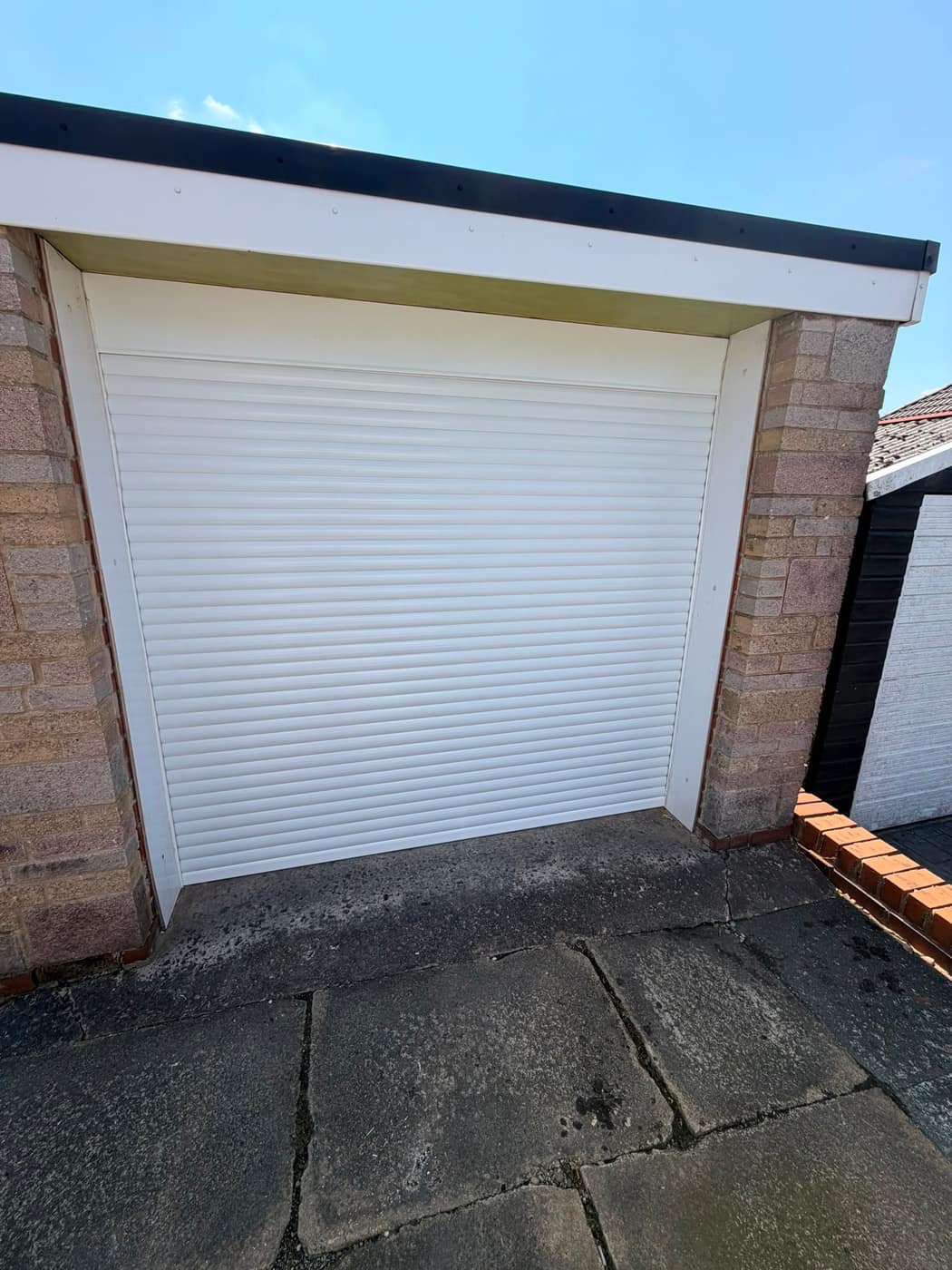 White insulated roller shutter fitted to a domestic garage