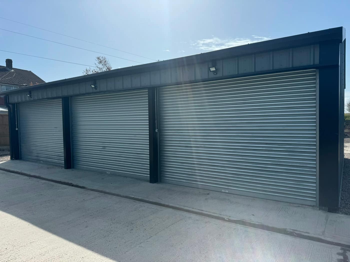Galvanised roller shutters fitted to a block of garages