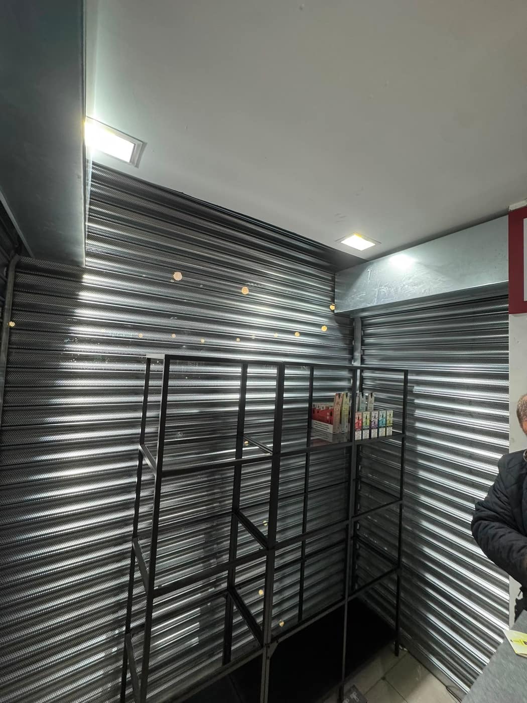 Steel security grille and shutters fitted to a storeroom