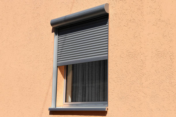 Anthracite window roller shutter on a rendered wall