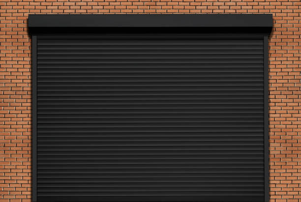 Black roller shutter on a brick garage