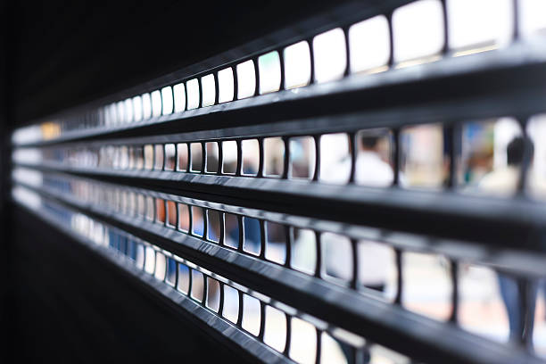 Row of security roller shutters seen in perspective