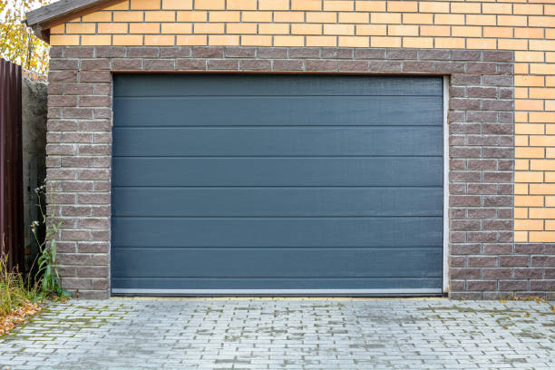Grey sectional garage door on a brick garage