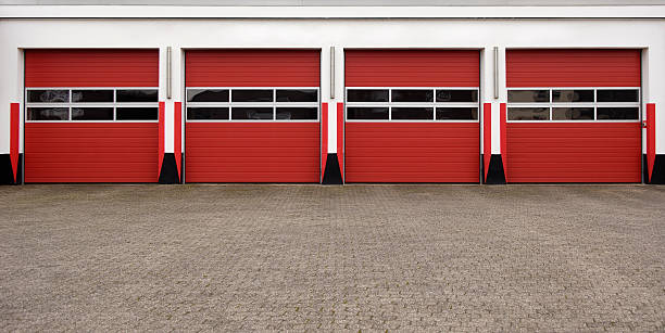 Red and white industrial sectional doors on a depot