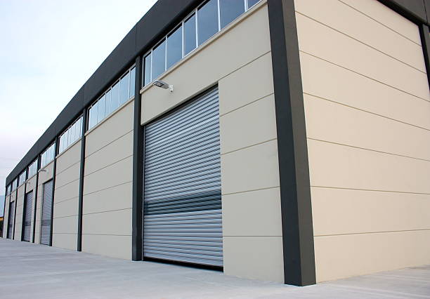 Beige insulated roller shutter on a commercial unit