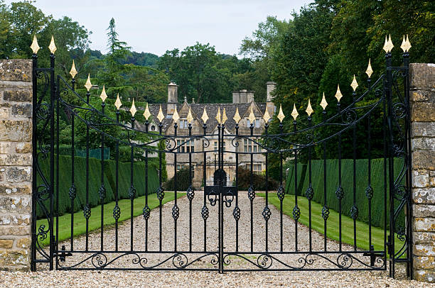 Ornate wrought iron estate gates with gold finials
