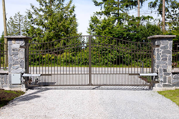 Sliding metal driveway gate on a gravel drive